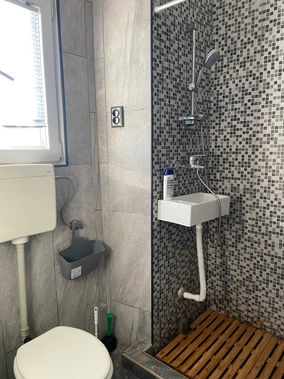 Shower room with mosaic tiles and a washbasin